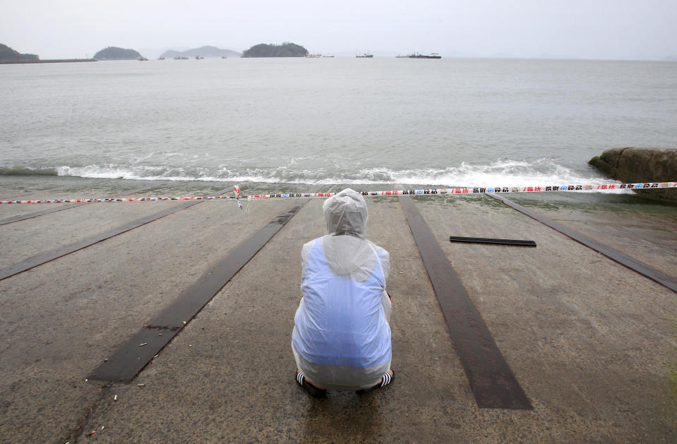 A relative of a passenger aboard the sunken Sewol ferry looks toward the sea as he awaits news on his missing loved one at a port in Jindo, South Korea, Sunday, April 27, 2014. South Korean Prime Minister Chung Hong-won offered to resign Sunday over the government's handling of the deadly ferry sinking, blaming "deep-rooted evils" and irregularities in a society for a tragedy that has left more than 300 people dead or missing and led to widespread shame, fury and finger-pointing.(AP Photo/Ahn Young-joon)