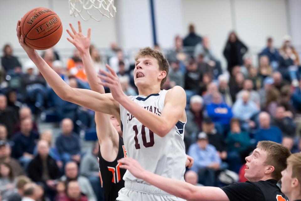 New Oxford's Tommy Haugh goes for a layup in the fourth quarter of a YAIAA tournament quarterfinal game against Hanover in West York on Friday, Feb. 7, 2020. The Colonials won, 69-41.