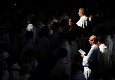 Members of the clergy pray as Pope Francis leads a mass at the Sanctuary of John Paul II during the World Youth Day in Krakow, Poland July 30, 2016. REUTERS/Stefano Rellandini