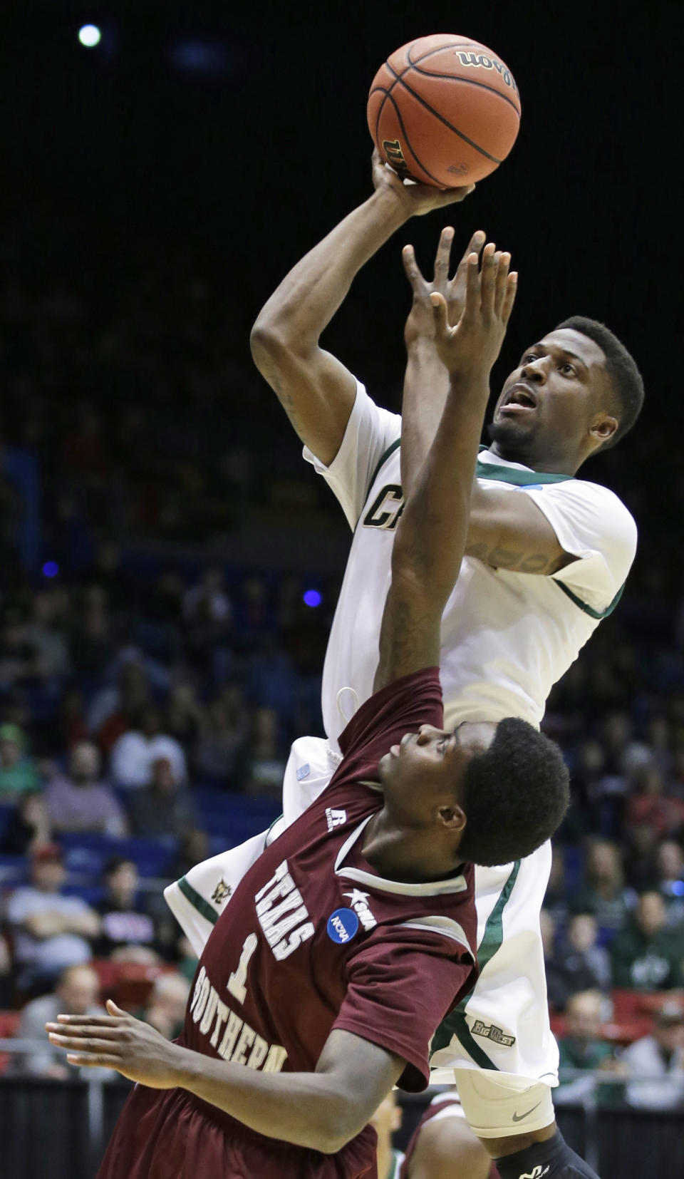 Cal Poly guard Dave Nwaba, top, shoots over Texas Southern guard D.D. Scarver (1) in the first half of a first-round game of the NCAA college basketball tournament on Wednesday, March 19, 2014, in Dayton, Ohio. (AP Photo/Al Behrman)