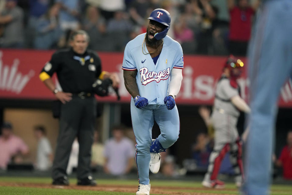 Texas Rangers' Adolis Garcia reacts after hitting a solo home run during the ninth inning of a baseball game against the Minnesota Twins in Arlington, Texas, Sunday, Sept. 3, 2023. (AP Photo/LM Otero)