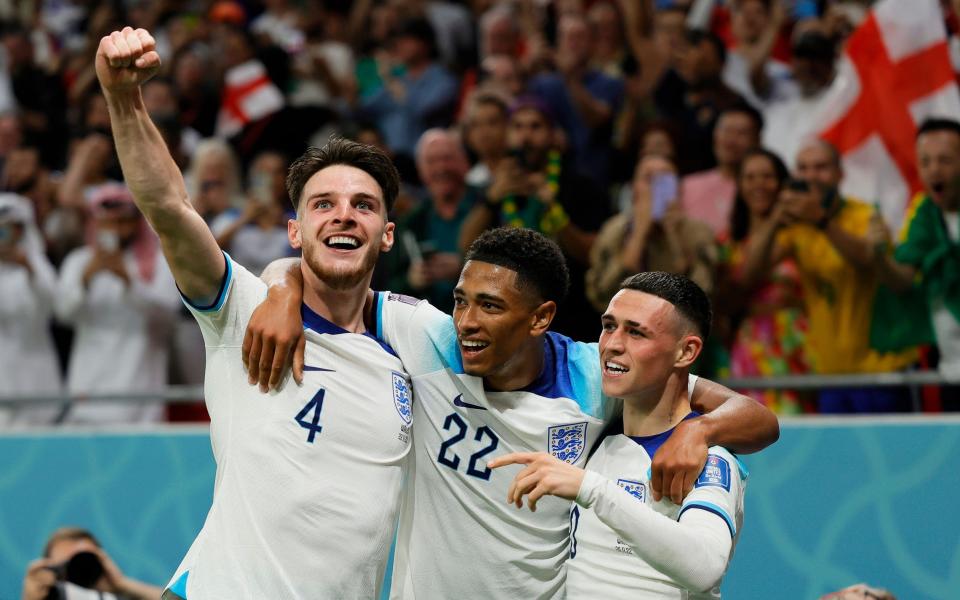 Phil Foden celebrates with teammates after scoring the 2-0 lead during the FIFA World Cup 2022 group B soccer match between Wales and England at Ahmad bin Ali Stadium - Shutterstock