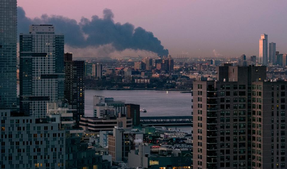 Smoke rises south of the New York borough of Manhattan as a warehouse burns in Elizabeth, N.J., spreading smoke over the southern skyline of New York Friday, Jan. 5, 2024. (AP Photo/Craig Ruttle) ORG XMIT: NYCR104