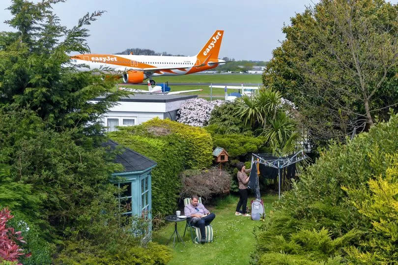 Alex and June Carr in their garden which backs on to Southend Airport, photographed in 2019