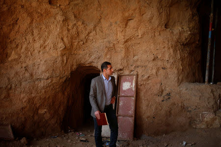 Archaeologist Musab Mohammed Jassim shows artefacts and archaeological pieces in a tunnel network running under the Mosque of Prophet Jonah, Nabi Yunus in Arabic, in eastern Mosul, Iraq March 9, 2017. Picture taken March 9, 2017. REUTERS/Suhaib Salem