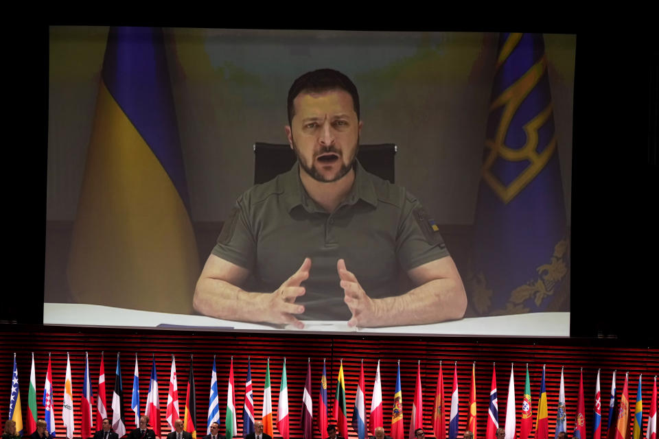 FILE- Ukraine's President Volodymyr Zelenskyy addresses, via videolink, the opening ceremony of the Council of Europe summit in Reykjavik, Iceland, May 16, 2023. The symbolism will be palpable when leaders of the world’s rich democracies sit down in Hiroshima later this week. The Japanese city's name evokes the tragedy of war, and the leaders will tackle a host of challenges including Russia’s invasion of Ukraine and rising tensions in Asia. (AP Photo/Alastair Grant, Pool)