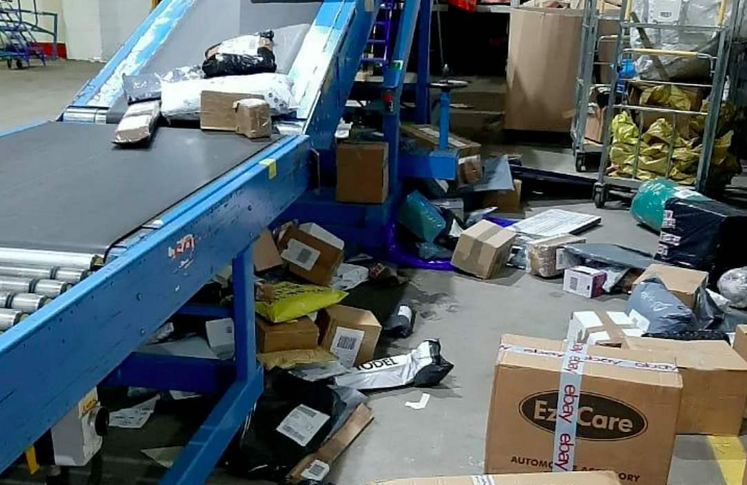 Some items in the Hermes depot are seen scattered on the ground after seemingly falling off the side of a conveyor belt (SWNS)