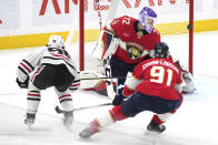 Chicago Blackhawks center Connor Bedard (98) scores past Florida Panthers goaltender Sergei Bobrovsky (72) as defenseman Oliver Ekman-Larsson (91) follows on the play during the second period of an NHL hockey game Sunday, Nov. 12, 2023, in Sunrise, Fla. (AP Photo/Jim Rassol)