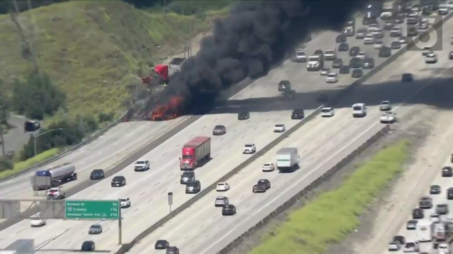 A very large fire tore through a semi-truck on the 5 Freeway on Wednesday afternoon, sending thick plumes of black smoke into the sky and causing heavy traffic delays. (Sky5)