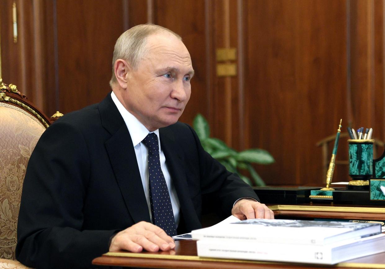 Vladimir Putin attends a meeting with Rostec state corporation CEO Sergei Chemezov in Moscow (via REUTERS)