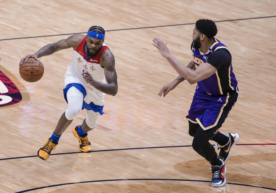 New Orleans Pelicans forward Naji Marshall (8) drives on Los Angeles Lakers forward Anthony Davis (3) in the third quarter of an NBA basketball game in New Orleans, Sunday, May 16, 2021. (AP Photo/Derick Hingle)