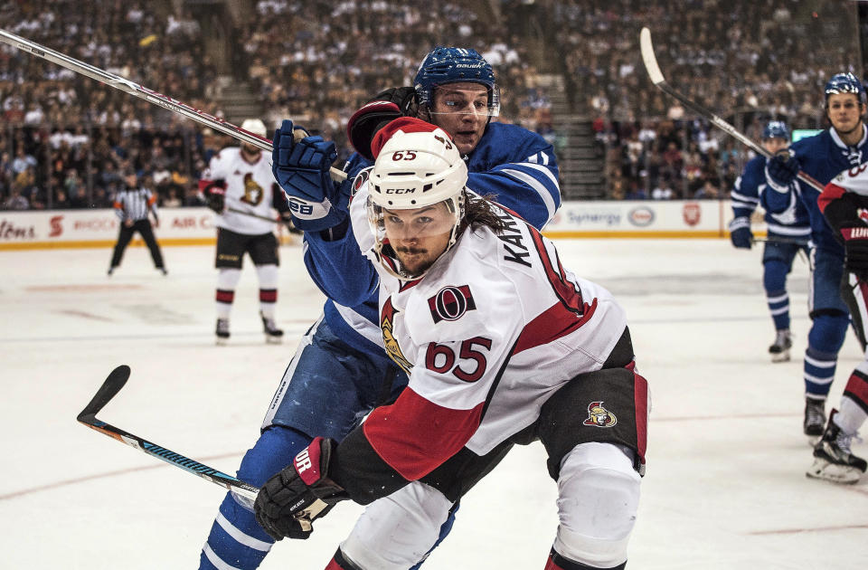 FILE - In this Feb. 18 2017, file photo, Ottawa Senators defenseman Erik Karlsson (65) fends of Toronto Maple Leafs centre Zach Hyman (11) during the second period of an NHL hockey game in Toronto. The San Jose Sharks have acquired two-time Norris Trophy-winning defenseman Erik Karlsson from the Senators, the teams announced Thursday, Sept. 13, 2018. (Aaron Vincent Elkaim/The Canadian Press via AP, File)