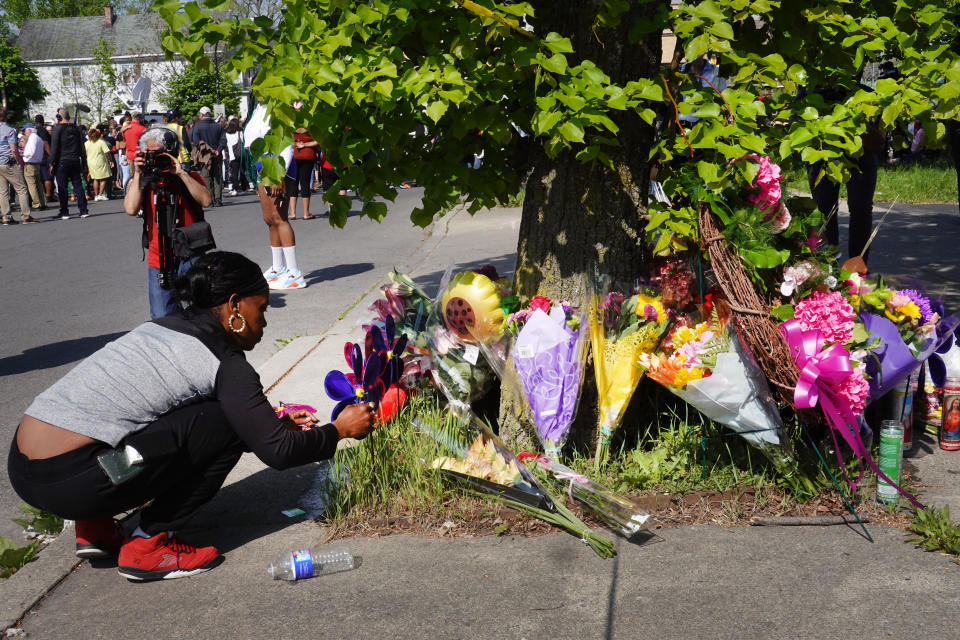 Flowers are left at a makeshift memorial outside of Tops Friendly Markets in Buffalo, New York, on May 15, 2022. / Credit: Getty Images