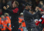 Liverpool's coach Juergen Klopp, right, celebrates after his side score their first goal during the Champions League Group C soccer match between Liverpool and Paris-Saint-Germain at Anfield stadium in Liverpool, England, Tuesday, Sept. 18, 2018. (AP Photo/Dave Thompson)