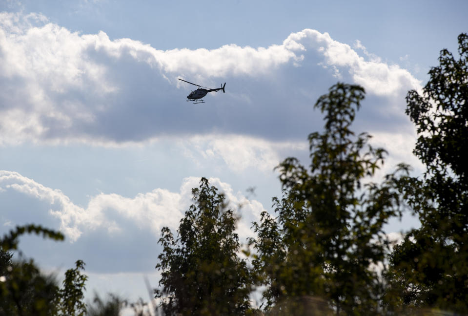 A law enforcement helicopter hovers over the location of a debris field from the crash of a stealth fighter jet in Williamsburg County, S.C., on Monday, Sept. 18, 2023. (Henry Taylor/The Post And Courier via AP)