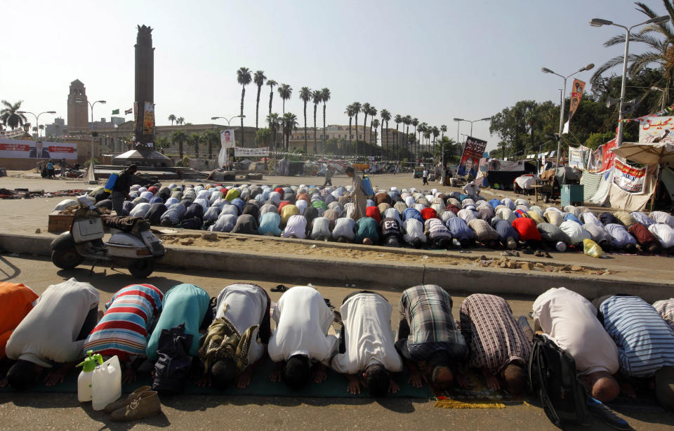 Supporters of Egypt's ousted President Mohammed Morsi pray in a park in front of Cairo University, where protesters have installed their camp in Giza, southwest of Cairo, Egypt, Thursday, Aug. 1, 2013. (AP Photo/Amr Nabil)