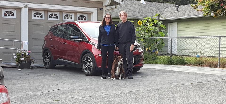 Douglas Shrock, his wife Guri Andermann and their dog Maggie with the 2020 Chevrolet Bolt. Shrock is not concerned about the recall on his car and says he loves the vehicle.