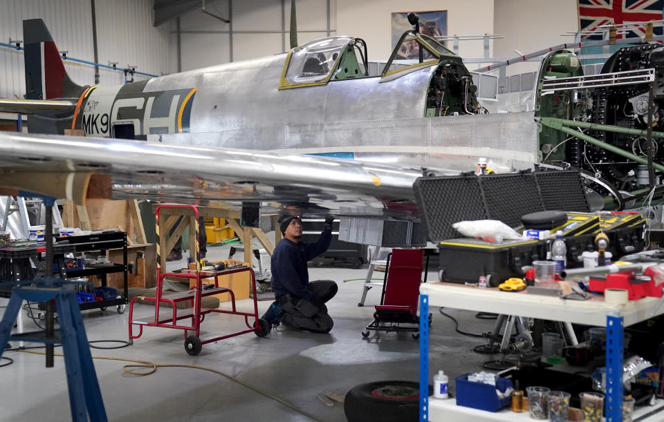 An engineer works on the restoration of a Spitfire inside the Heritage Hangar at Biggin Hill Airport in Kent (Gareth Fuller/PA Wire)