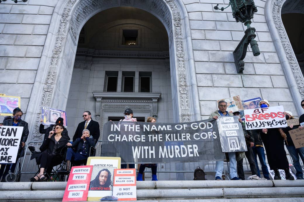 Attendees at the Keita O’Neil rally hold a banner and signs in front of the California attorney general's office in San Francisco on March 6, 2023.