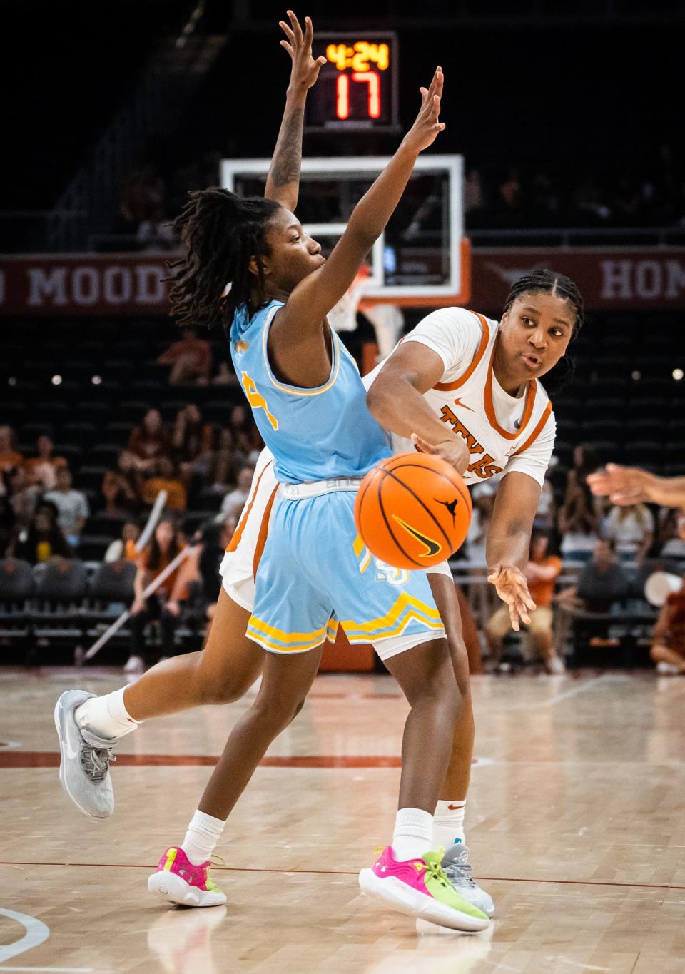 Texas forward Madison Booker slots a pass to a teammate around defense from Southern guard Chloe Fleming during the Longhorns' game against the Jaguars at Moody Center on Nov. 8. Texas won the game 80-35.
