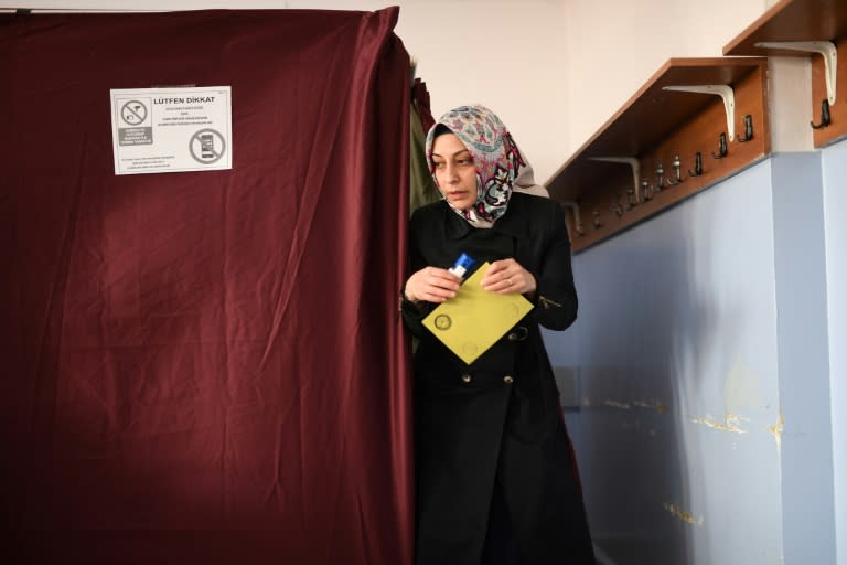 A woman walks to the ballot box to place her vote in the referendum on expanding the powers of the Turkish president on April 16, 2017 in Istanbul