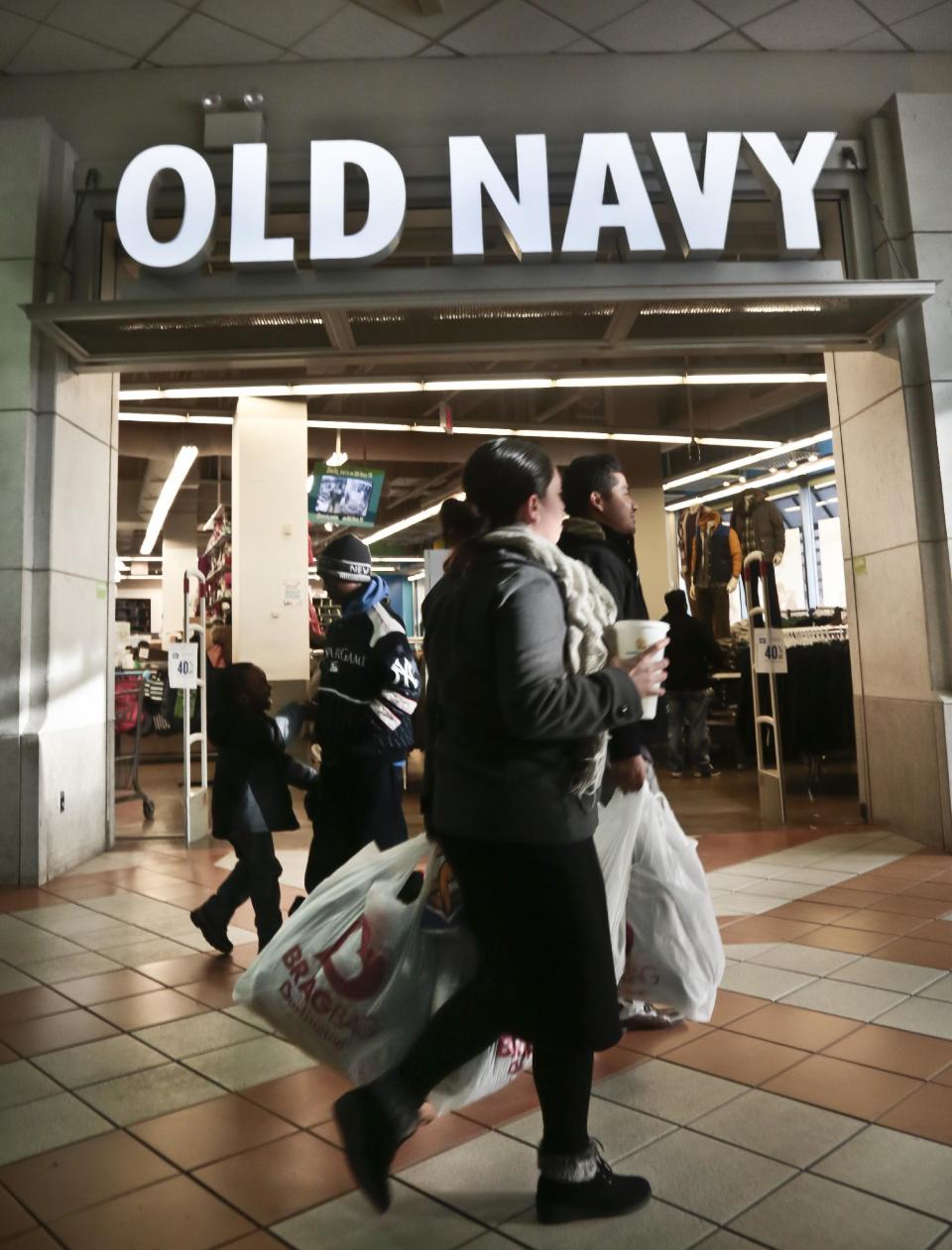 FILE - This Nov. 23, 2013 file photo shows shoppers approach Old Navy store at Atlantic Terminal Mall in New York. Getting up early on Black Friday for a little shopping? Doing your part on Small Business Saturday and Cyber Monday, too? It’s all in the name of gift-giving _ or at least the guise of it. It seems a lot of consumers are using these sales and retail events to treat themselves to a new little something. (AP Photo/Bebeto Matthews, File)