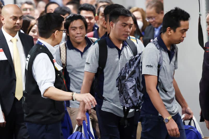 Filipino seafarers who survived the deadly Houthi attack on the commercial ship True Confidence arrive at Manila International Airport