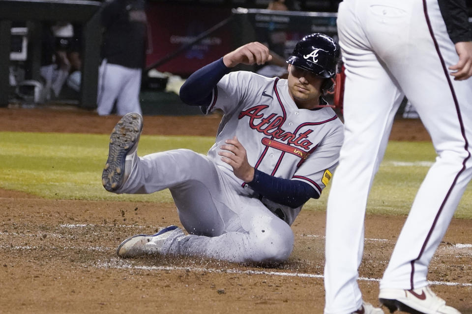 Atlanta Braves' Austin Riley scores against the Arizona Diamondbacks during the fifth inning of a baseball game Saturday, June 3, 2023, in Phoenix. (AP Photo/Darryl Webb)