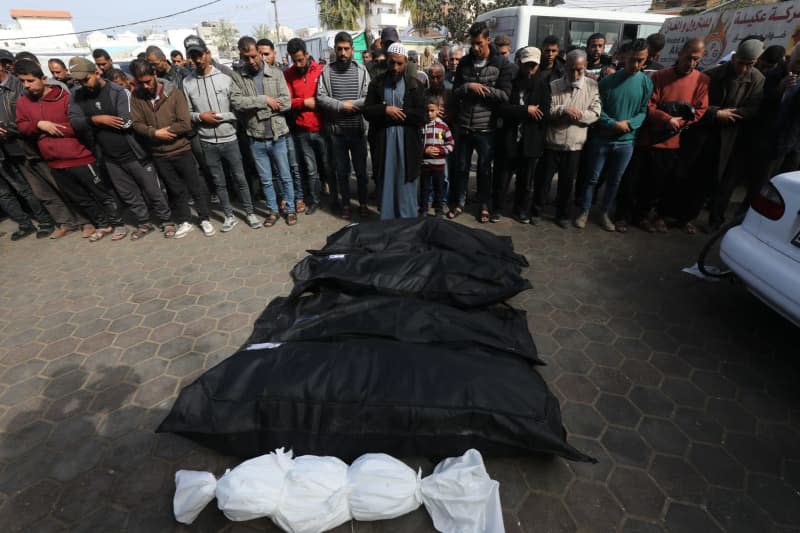 Palestinians perform funeral prayers behind the bodies of those who were killed in Israeli attacks, outside the morgue of Al-Aqsa Hospital in Deir El-Balah. Omar Ashtawy/APA Images via ZUMA Press Wire/dpa