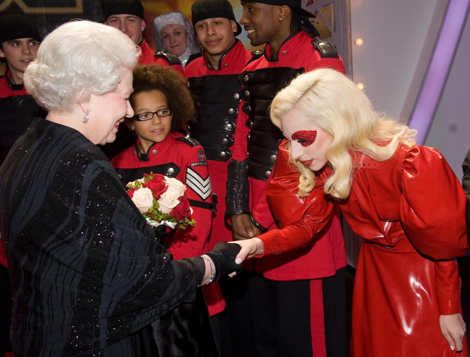 Britain's Queen Elizabeth II (L) meets American singer Lady Gaga (R) following the Royal Variety Performance in Blackpool, England on December 7, 2009. Returning to the town for the first time since 1955, the annual show features a wide range of artists from all aspects of popular entertainment and showbusiness. AFP PHOTO/Leon Neal/POOL (Photo by LEON NEAL / AFP) (Photo by LEON NEAL/AFP via Getty Images)
