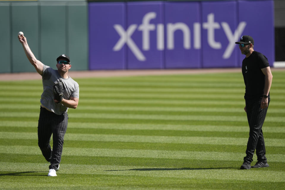 Chicago White Sox pitcher Liam Hendriks, left, throws as pitching coach Ethan Katz watches before a baseball game against the Los Angeles Angels, Monday, May 29, 2023, in Chicago. The White Sox returned Hendriks from his injury rehabilitation assignment with Triple-A Charlotte and reinstated him from the 15-day injured list Monday. (AP Photo/Charles Rex Arbogast)
