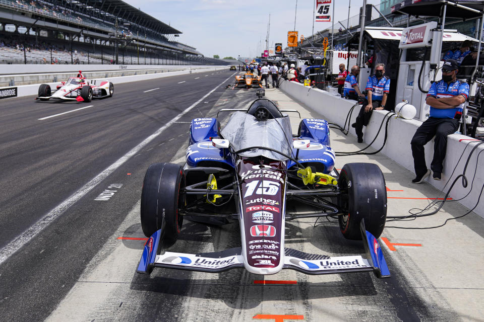 The car driven by Graham Rahal sits in the pit area in the opening 30 minutes of practice for the Indianapolis 500 auto race at Indianapolis Motor Speedway in Indianapolis, Friday, May 21, 2021. IndyCar has punished Rahal Letterman Lanigan for trying to stage a photo in the opening minutes of Thursday's practice and were force to sit out the first 30 minutes of practice on Friday. (AP Photo/Michael Conroy)