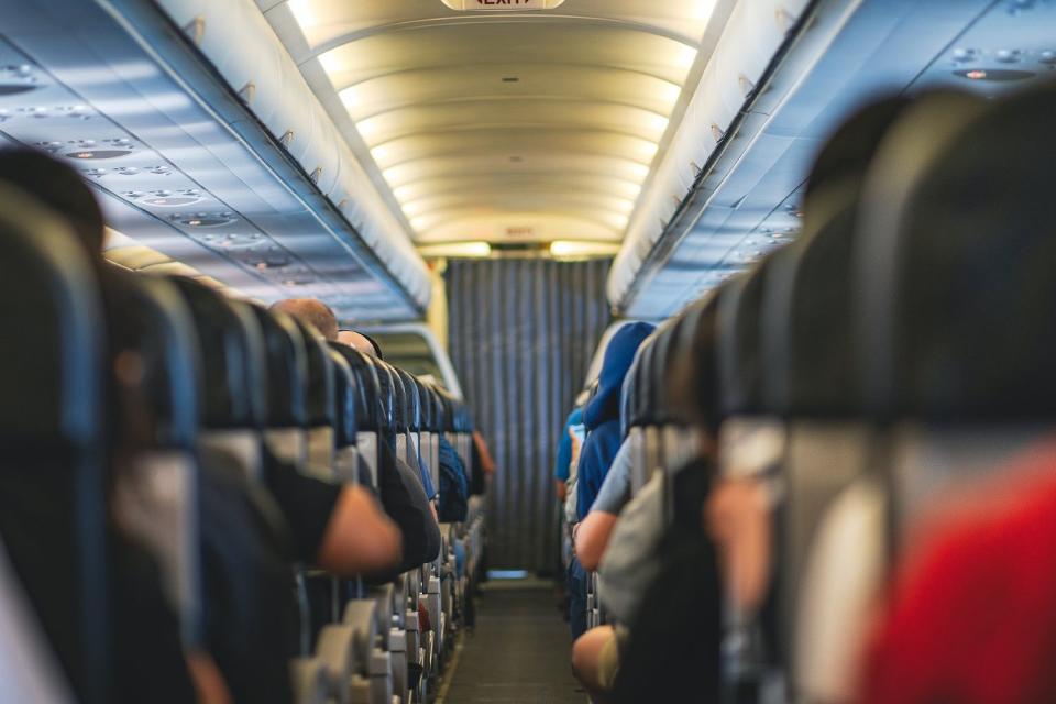 <p>Natnan Srisuwan/Getty</p> Passengers on an airplane