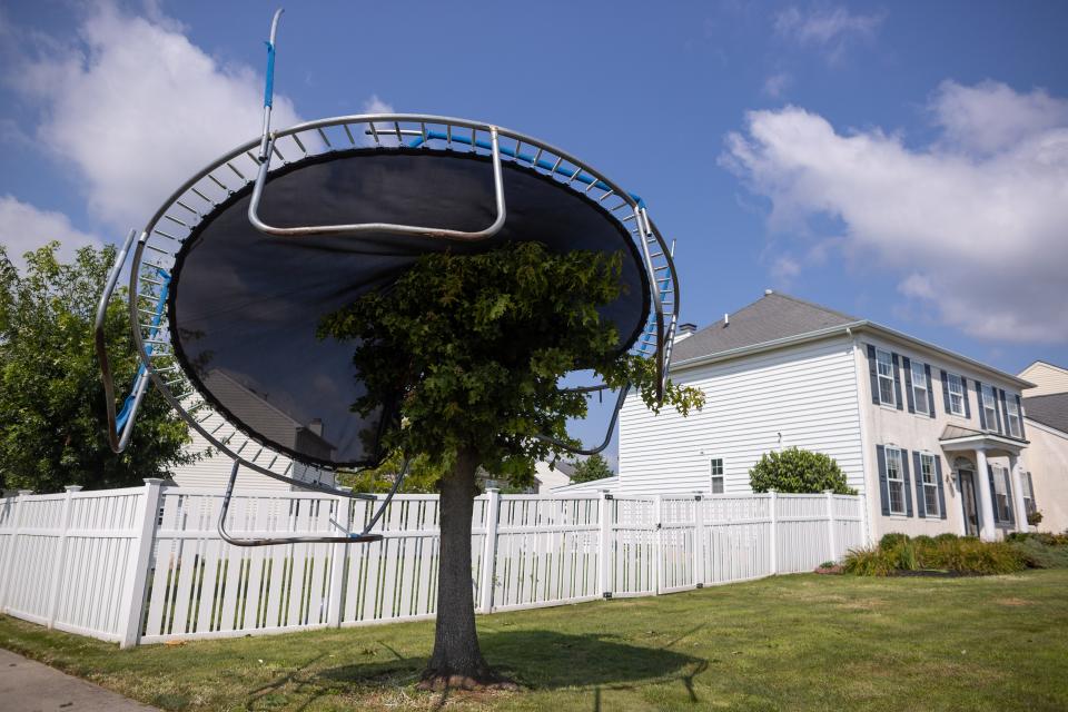 A trampoline balance on top of a small tree off Tatham Rd. in Bensalem on Friday, July 30, 2021. A tornado caused major damage to the area Thursday evening.