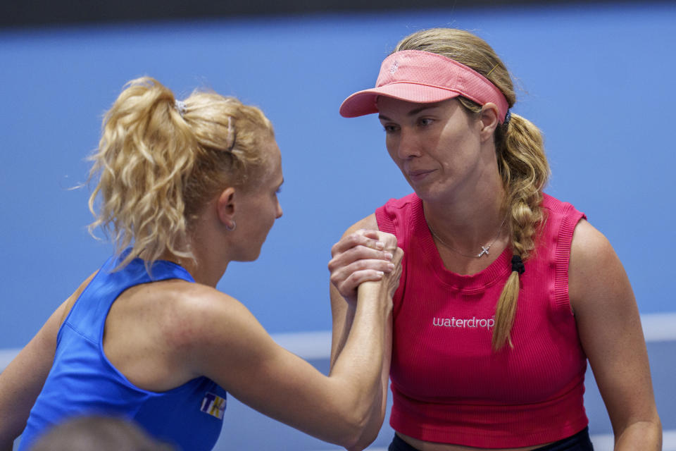 US Danielle Collins, right, shakes hands after defeating Czech Republic's Katerina Siniakova during their group stage tennis match at the Billie Jean King Cup finals at La Cartuja stadium in Seville, southern Spain, Spain, Friday, Nov. 10, 2023. (AP Photo/Manu Fernandez)