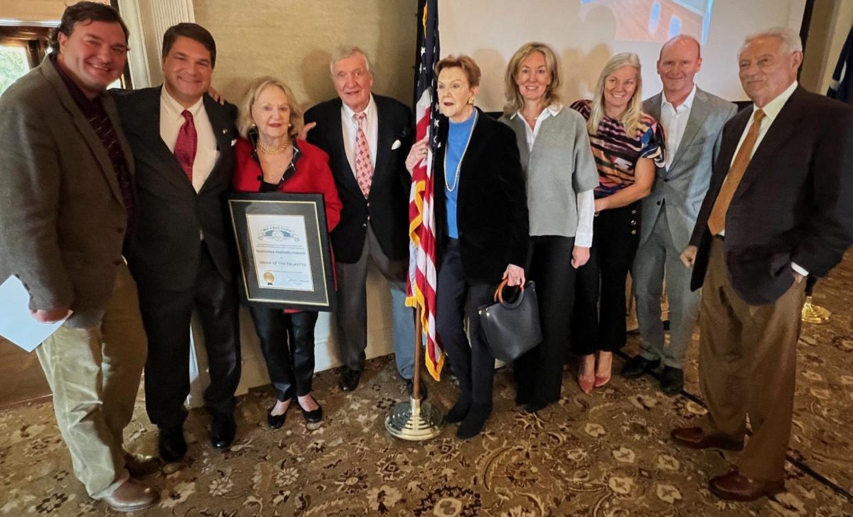 Marianna Black Habisreutinger of Spartanburg was awarded the Order of Palmetto by state Rep. Max Hyde of Spartanburg. Pictured with them are family members aat Spartanburg's Piedmont Club, Monday.
