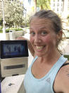 In this selfie provided by Beth Berglin, she shows a screen where she joins a Burn Boot Camp live stream workout from her home Thursday, March 19, 2020, in Coral Gables, Fla. People around the country who are self-isolating or maintaining social distance during the coronavirus outbreak have to think outside the gym when it comes to their fitness routines. Many are turning to online classes or getting outside to exercise. (Beth Berglin via AP)