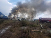 <p>Firefighters douse a fire as smoke billows above the site where an Aeromexico-operated Embraer passenger jet crashed in Mexico’s northern state of Durango, July 31, 2018, in this picture obtained from social media. (Photo: Proteccion Civil Durango via Reuters) </p>