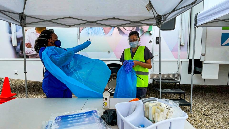 Community health workers with Healthcare Network prepare for a COVID-19 testing event on Wednesday, Aug. 4, 2021, in Immokalee, Florida.