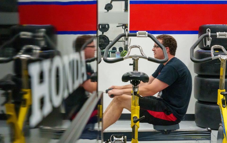 Keith Gummer, an inside rear pit crew member on the team of Andretti Autosport driver Colton Herta, uses a row machine Tuesday, May 9, 2023, during a cardio day of training at the Indianapolis facility.