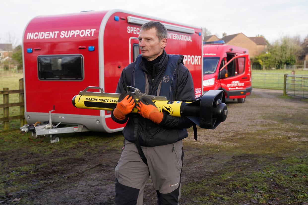 A searcher from a private underwater search and recovery company, Specialist Group International, carries an 18 kHz side-scan sonar to a rigid inflatable boat (rib) in St Michael's on Wyre, Lancashire, as they assist in the search for missing woman Nicola Bulley, 45, who was last seen on the morning of Friday January 27, when she was spotted walking her dog on a footpath by the nearby River Wyre. Picture date: Monday February 6, 2023.