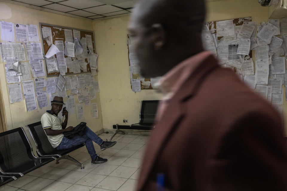 An employee sits inside the Justice of Palace, in Port-au-Prince, Haiti, Thursday, Sept. 16, 2021. Even before the assassination of President Jovenel Moise in July, the government was weak -- the Palace of Justice inactive, congress disbanded by Moise and the legislative building pocked by bullets. (AP Photo/Rodrigo Abd)