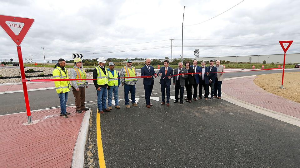 Matt Walter, capital program administrator for Ohio Department of Transportation's District 3, and Mayor Matt Miller cut the ribbon at the ceremony for Ashland County's first roundabout which opened Thursday at U.S. Route 250, state Route 60 and Faultless Drive on Thursday, Sept. 29, 2022. TOM E. PUSKAR/ASHLAND TIMES-GAZETTE