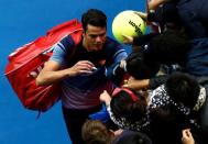 Canada's Milos Raonic signs autographs after winning his fourth round match against Switzerland's Stan Wawrinka at the Australian Open tennis tournament at Melbourne Park, Australia, January 25, 2016. REUTERS/Jason Reed