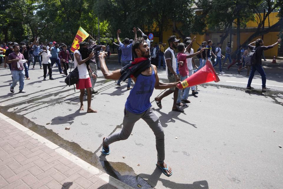 Protesters storm the compound of Sri Lankan Prime Minister Ranil Wickremesinghe's office, demanding he resign after president Gotabaya Rajapaksa fled the country amid economic crisis in Colombo, Sri Lanka, Wednesday, July 13, 2022. Rajapaksa fled on a military jet on Wednesday after angry protesters seized his home and office, and appointed Prime Minister Ranil Wickremesinghe as acting president while he is overseas. Wickremesinghe quickly declared a nationwide state of emergency to counter swelling protests over the country's economic and political collapse. (AP Photo/Eranga Jayawardena)