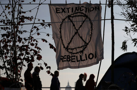 An Extinction Rebellion banner hangs on the Waterloo Bridge during an Extinction Rebellion protest in London, Britain April 19, 2019. REUTERS/Hannah McKay