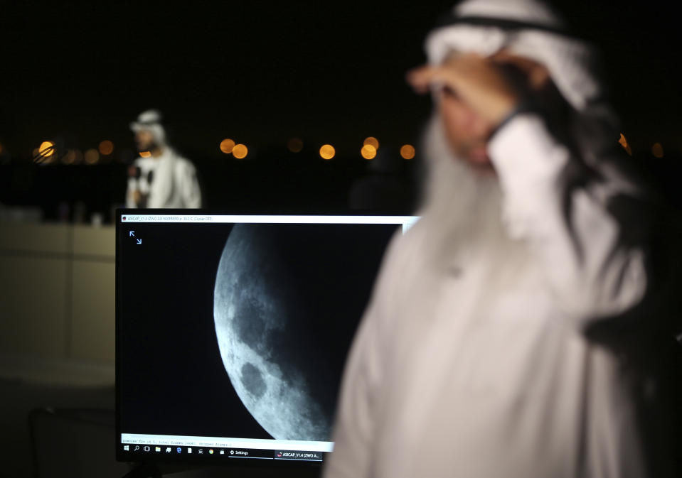 <p>The lunar eclipse is shown on a screen at the Al Thuraya Astronomy Center in Dubai, United Arab Emirates, Friday, July 27, 2018. (Photo: Kamran Jebreili/AP) </p>