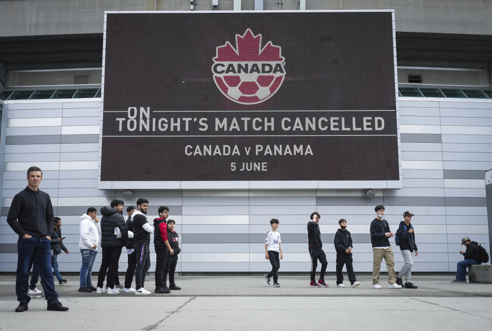 Fans gather outside B.C. Place stadium after the Canadian national men's soccer team's match against Panama was canceled due to a labor dispute, in Vancouver, British Columbia, Sunday, June 5, 2022. (Darryl Dyck/The Canadian Press via AP)