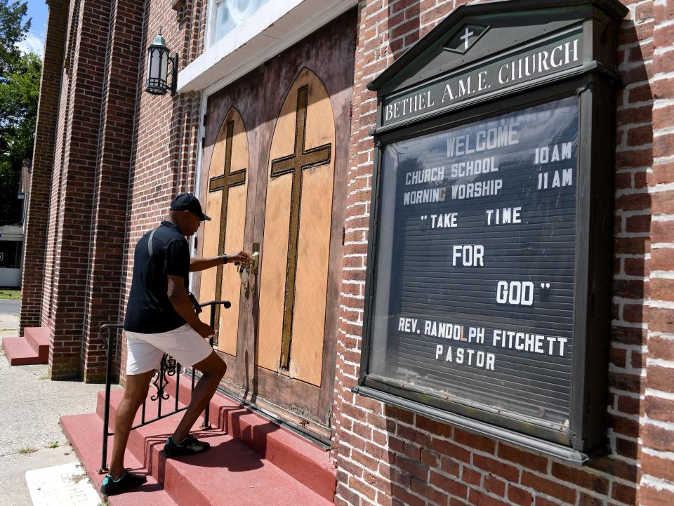 Dion Banks unlocks the door to Bethel AME Church July 14, 2023, in Cambridge, Maryland.