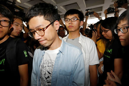 Student leaders Nathan Law and Joshua Wong walk into the High Court to face verdict on charges relating to the 2014 pro-democracy Umbrella Movement, also known as Occupy Central protests, in Hong Kong, China August 17, 2017. REUTERS/Tyrone Siu